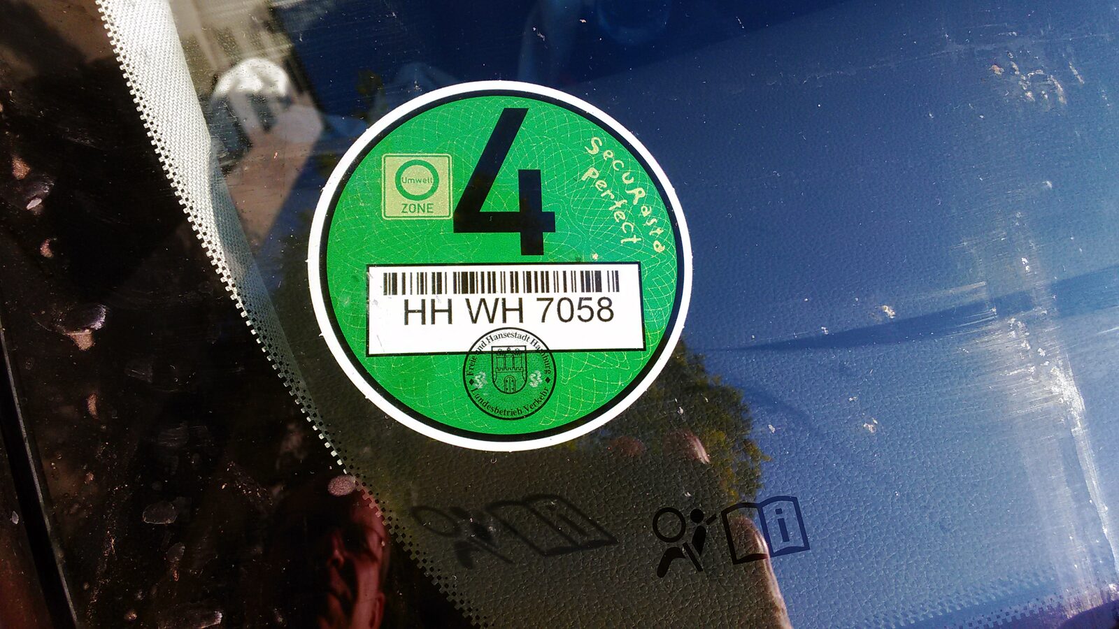Grüne Umweltplakette der Schadstoffgruppe 4 aus Hamburg an der Innenseite einer Windschutzscheibe (Foto: Mattes, CC BY 3.0 de)