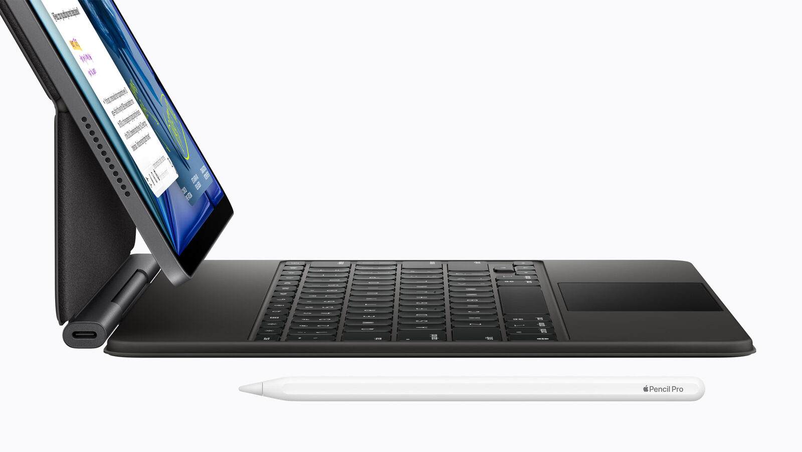 Magic Keyboard'a takılı uzay grisi iPad Air ve önünde Apple Pencil Pro'nun yandan görünümü