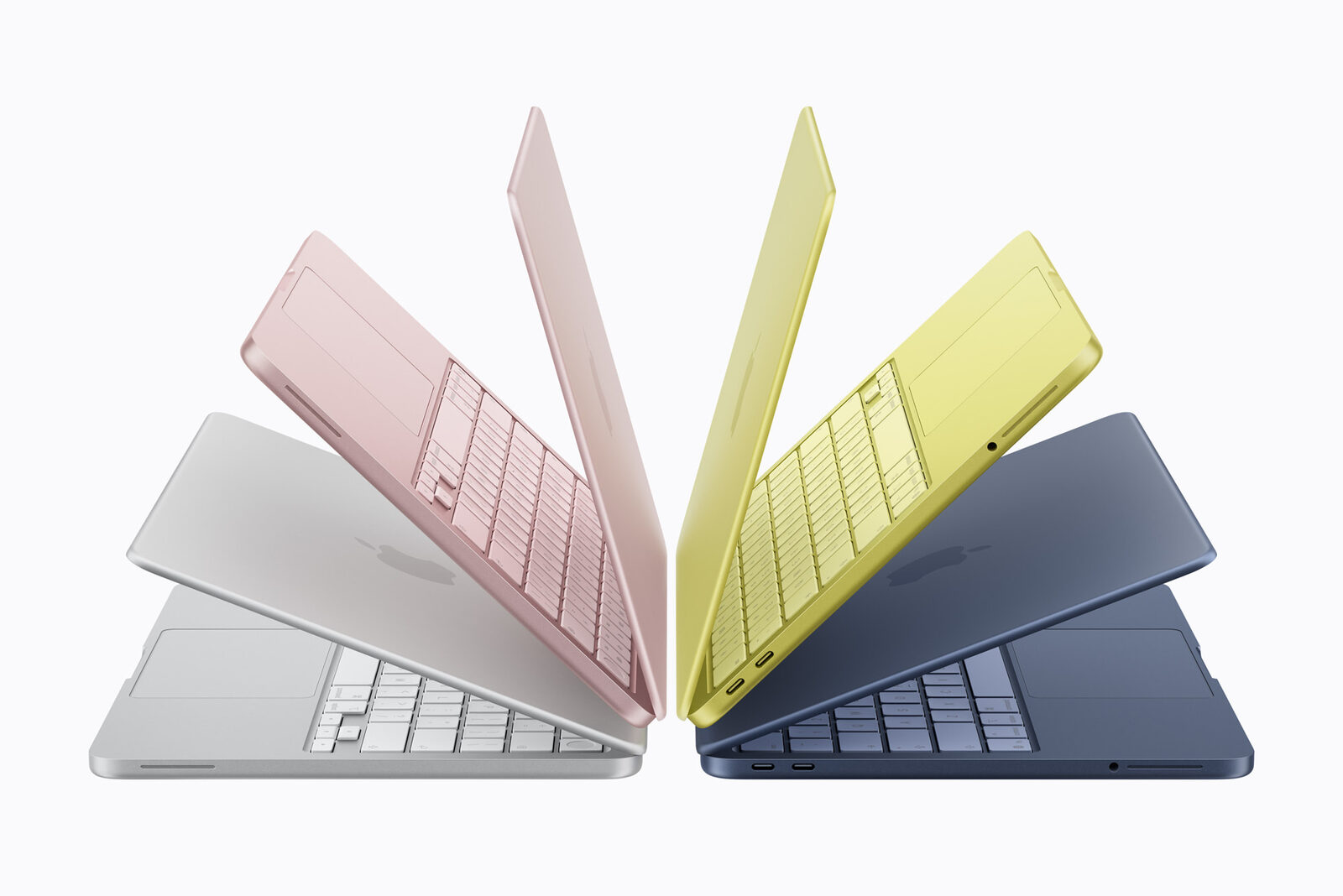 Gümüş, pembe, sarı ve lacivert renklerde yelpaze gibi açılmış dört MacBook Neo