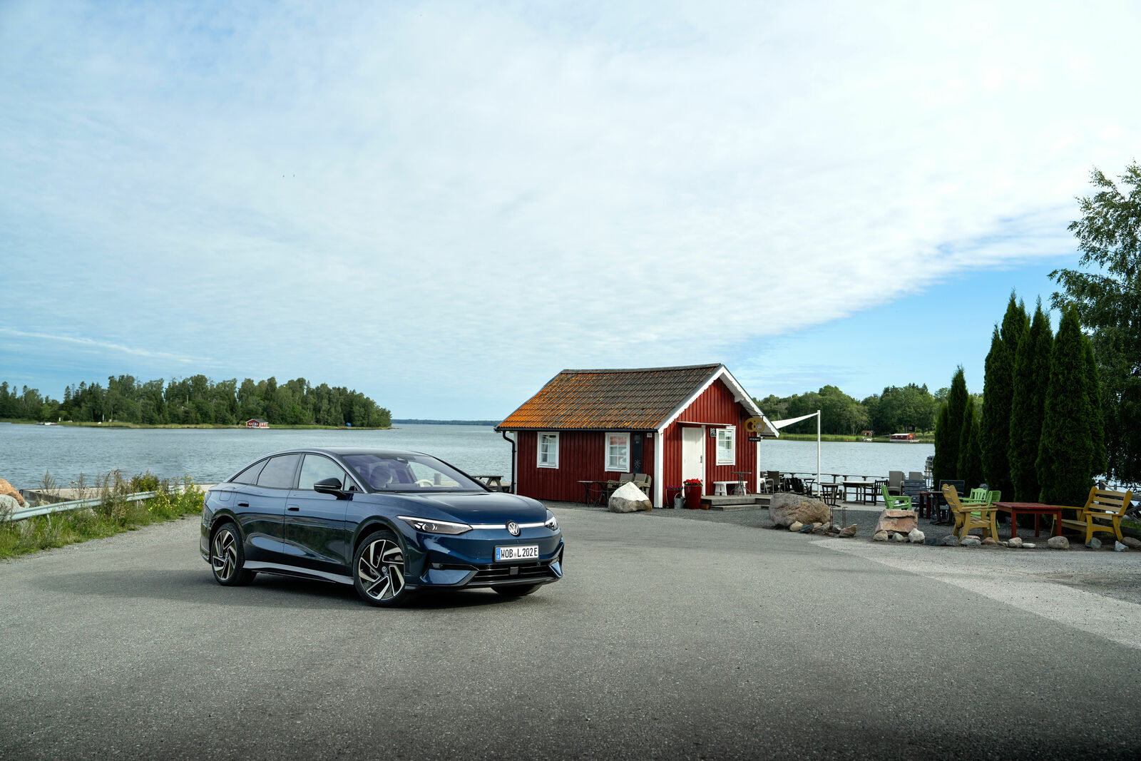 Koyu renk Volkswagen ID.7, göl kenarında önden görünüm