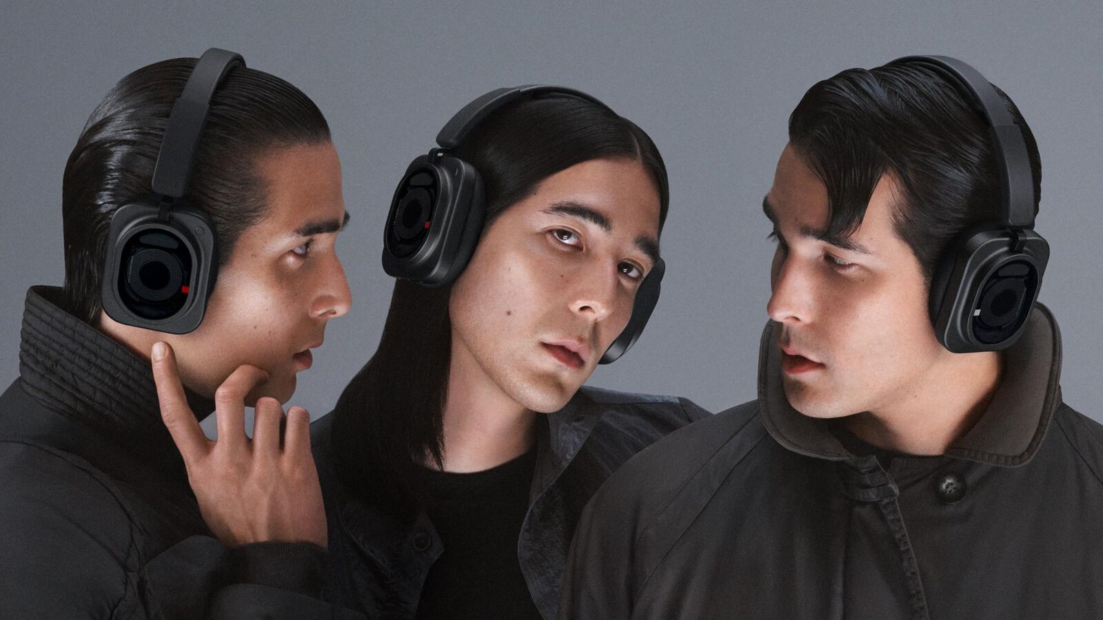 Siyah Nothing Headphone (1) Pro takmış üç kişi gri fon önünde